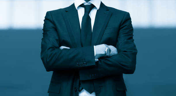 istock Success business man with arms crossed. Blue Toned Image. 688771494