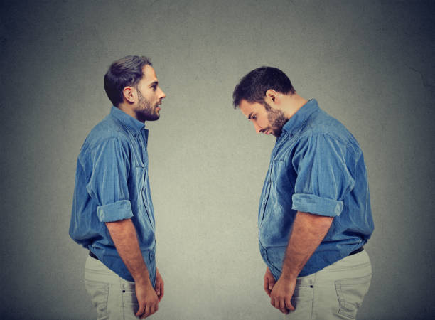 Slim guy looking at fat man himself. Diet choice right nutrition concept