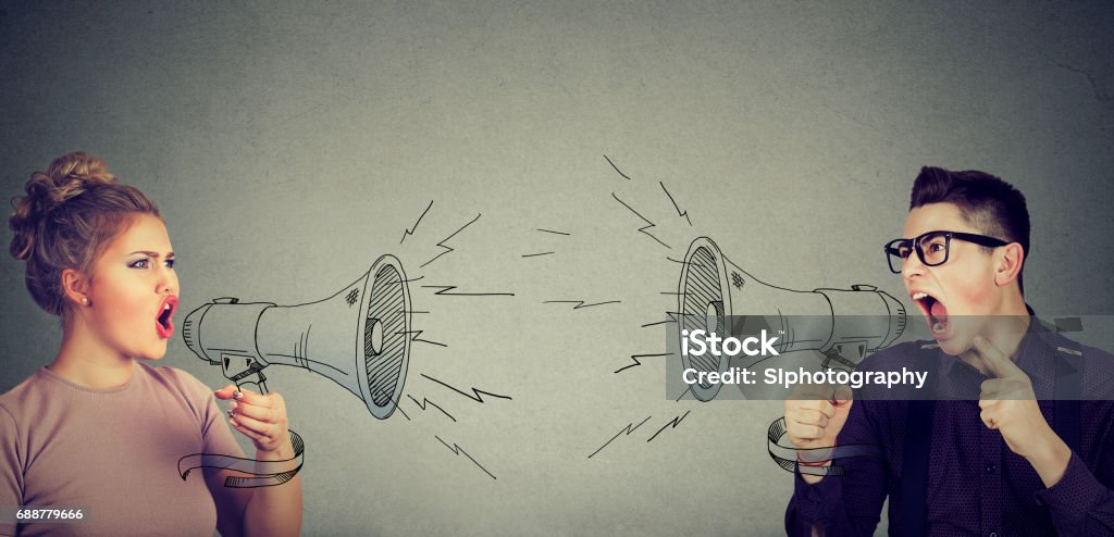 Quarrel between woman and man screaming at each other in megaphone Communication Stock Photo