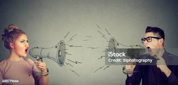 Quarrel Between Woman And Man Screaming At Each Other In Megaphone Stock Photo - Download Image Now