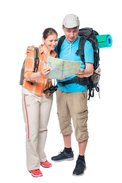 istock Happy woman and surprised man with a map with backpacks on a white background 688780346