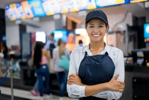 Photo of Portrait of a happy woman working at the cinema