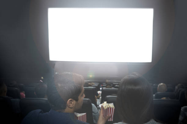 istock Couple at the cinema looking at a white screen 688783008