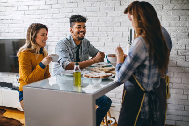 istock Mixed race couples laughing and preparing dinner together 688789882
