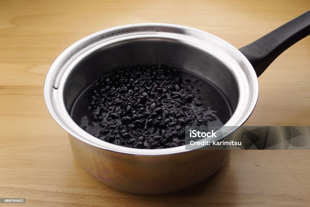 Stainless steel pot with Black beans in water, Adzuki Bean Stock Photo