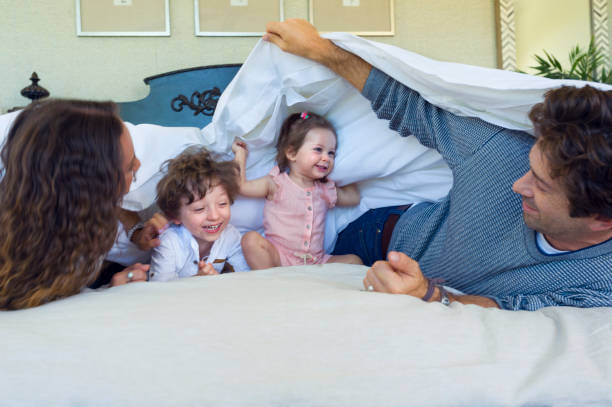 istock Family playing on a bed. 688796702