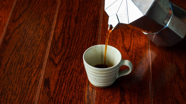 istock coffee flow from moka pot to a cup 688796754