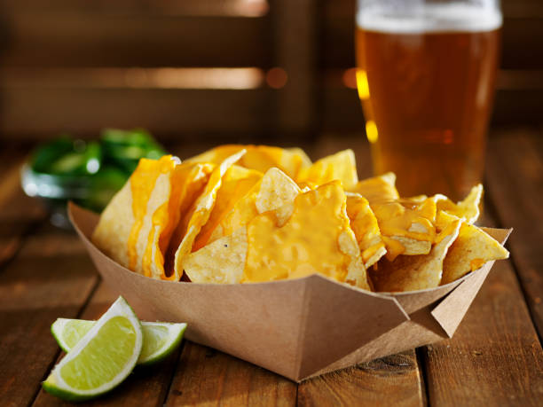 istock nachos and cheese in tray with beer 688805320