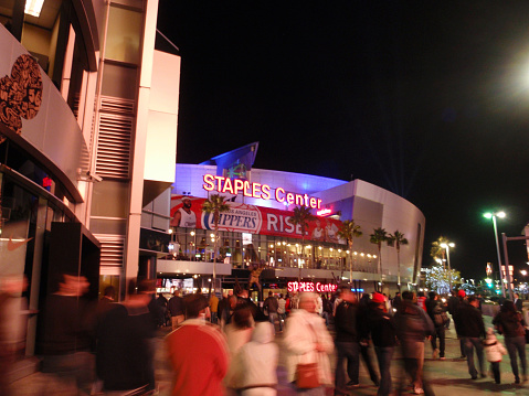 LOS ANGELES - NOVEMBER 25: Fans enter arena during Clippers game of the 2010-2011 NBA basketball season on November 25, 2010 in Los Angeles. Entrance of the Staples Center at night. It is 950,000 SF and is home to the Clippers and Laker teams and seats up to 19,060 for basketbal.