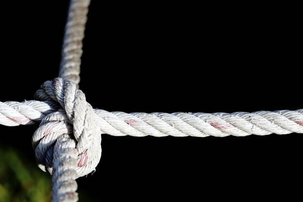 istock Nylon Rope Knot four ways, difficult hard to solve, black background 688812180