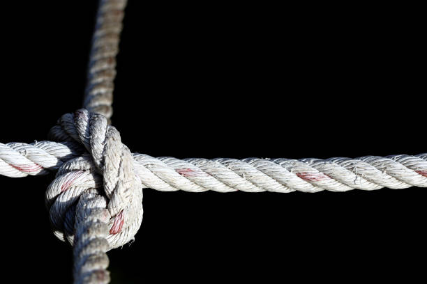 istock Nylon Rope Knot four ways, difficult hard to solve, black background 688812200