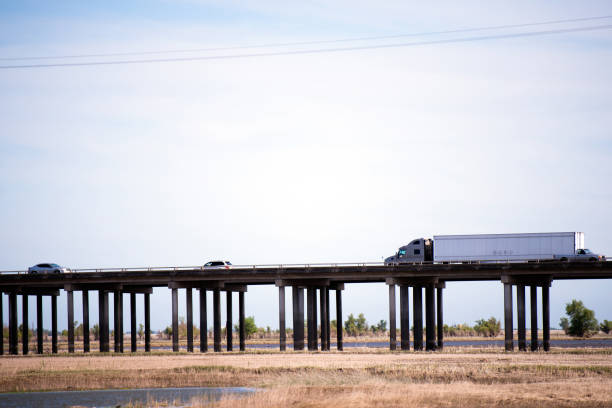 istock big rig semi truck going owerpass highway with support pols 688818976