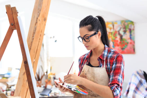 istock Young woman drawing in art studio 688819116