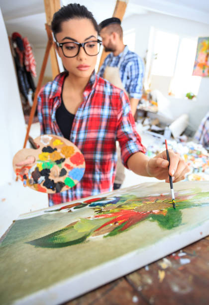 istock Young woman drawing in art studio 688819126