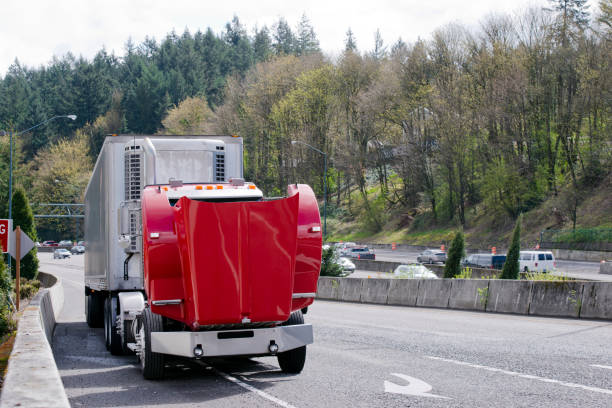 Broken on the road red semi truck with an open hood A large professional red big rig semi truck with reefer trailer broke engine on the road and standing with an open hood for repair work engine failure stock pictures, royalty-free photos & images