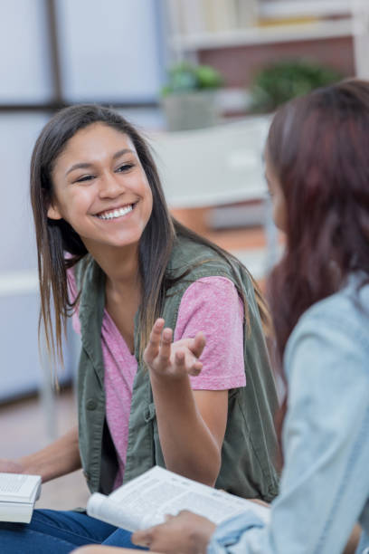 istock Beautiful female college student studies with her friend 688821472