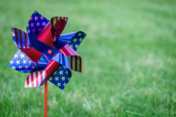 Single stars and stripes spinners in the yard with room for copy space.