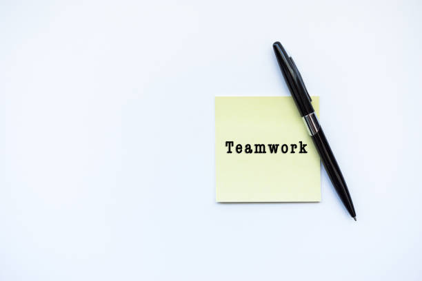 istock TEAMWORK word concept on sticky note and a pen over top view flat lay isolated on white background. 688831438