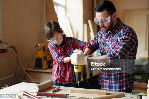 Drilling Plank Stock Photo - Download Image Now - Work Tool, Father, Son