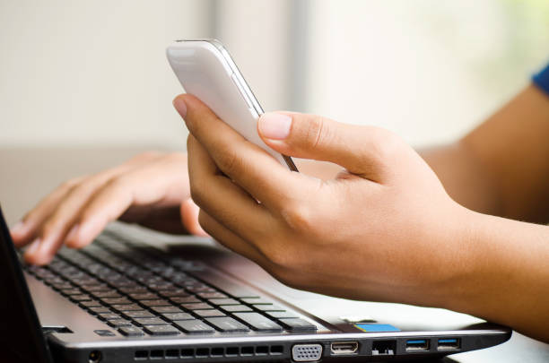 istock Man using smart phone and laptop for business working 688841366