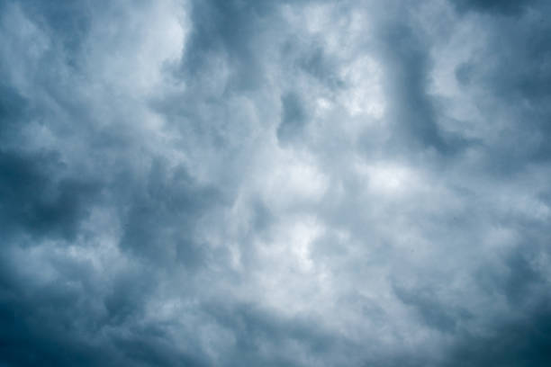 istock clouds with background,sunlight through very dark clouds background of dark storm clouds, black sky Background of dark clouds before a thunder. 688844032