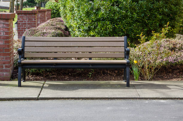 istock Wooden bench along the sidewalk 688848178