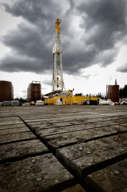 Oil Rig Large modern oil rig framed against a dramatic stormy sky with large amount of platform in the foreground oil pump petroleum equipment development stock pictures, royalty-free photos & images