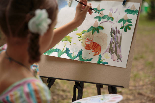 istock girl paints on an easel in the drawing lesson 688848658