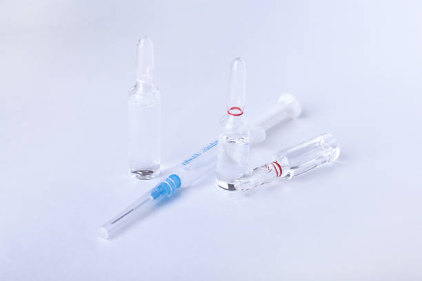 istock medical ampoules and syringe isolated on white background 688851220
