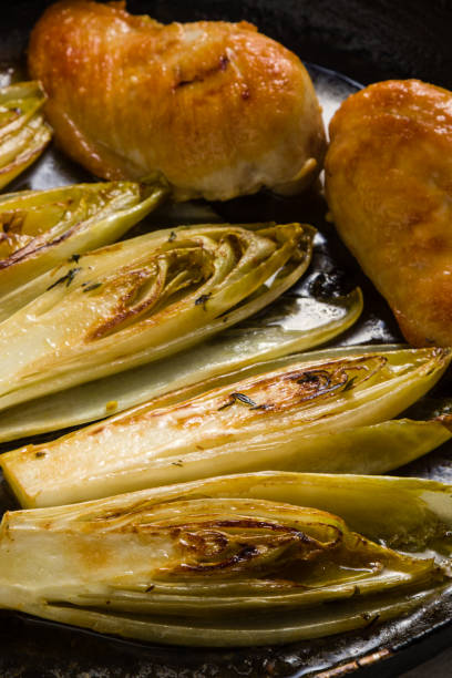 istock fried chicken and chicory in sauce 688867806