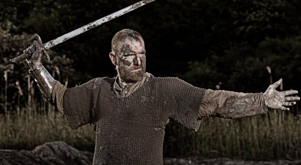 istock Sword wielding bloody and dirty viking warrior in countryside setting 688868934
