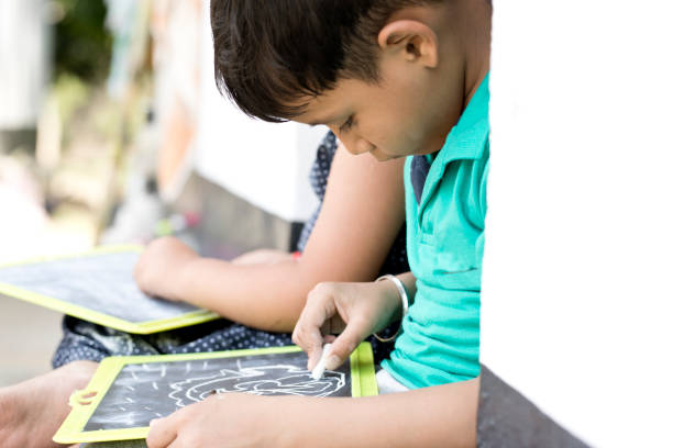 istock Boy and girl writing on slate 688869912