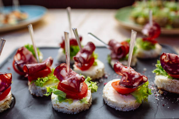 istock Snacks and appetizers. Spanish tapas on a black stone plate. 688869958