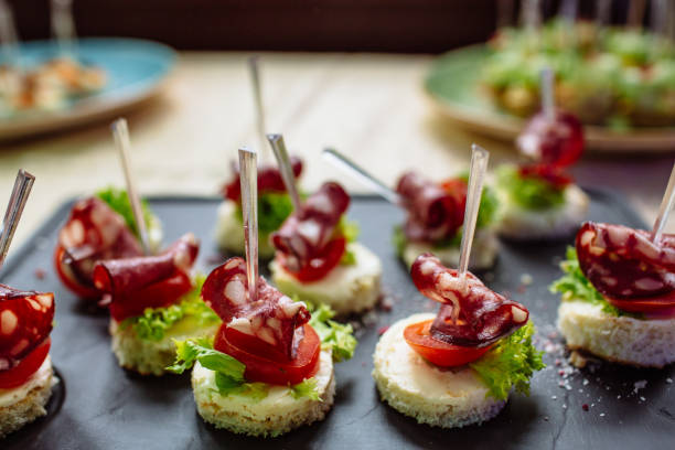 istock Snacks and appetizers. Spanish tapas on a black stone plate. 688870158