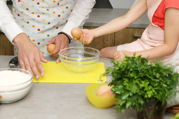 istock Parent and child cooking together. 688874580