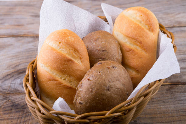istock Bread basket on a wooden board 688875672
