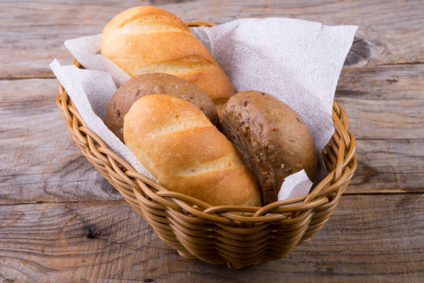 istock Bread basket on a wooden board 688875742