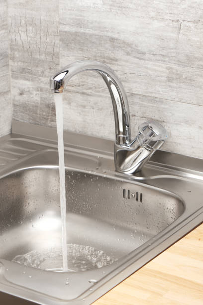 istock Kitchen sink with running tap water 688879260