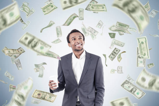 istock African man with coffee and dollar rain 688889376
