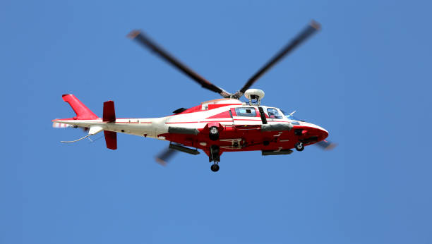 istock rescue helicopter flies fast in the blue sky 688889388