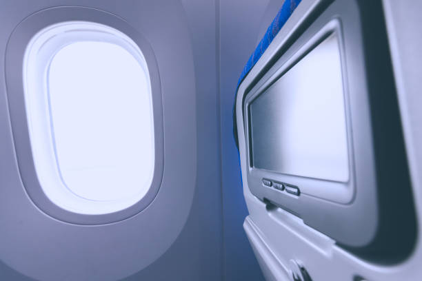 istock Airplane porthole and seat-back TV screen 688893068