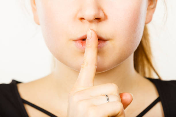 istock Woman showing silence gesture with finger 688895404