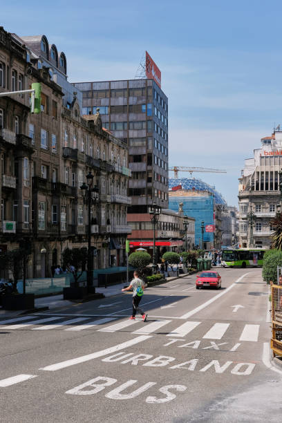 Vigo, Spain - May 26, 2017: Day shot of pedestrian crossing the street in the city center in Vigo, Spain