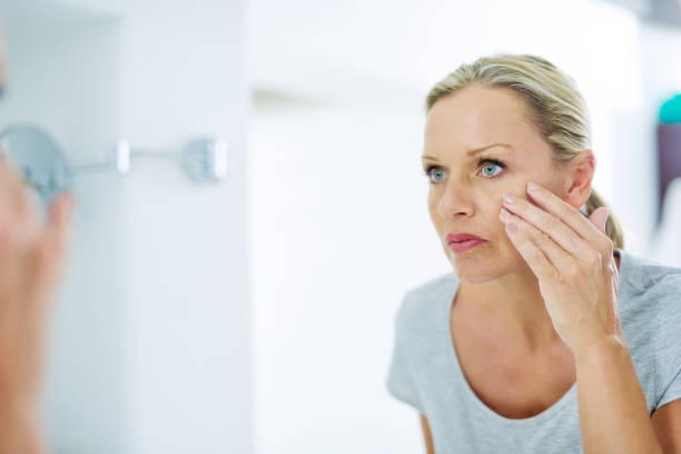 istock Analysing her skin for any blemishes 688899938