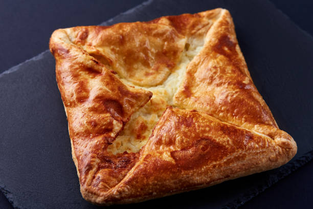 Homemade cheese puff pastries on black background