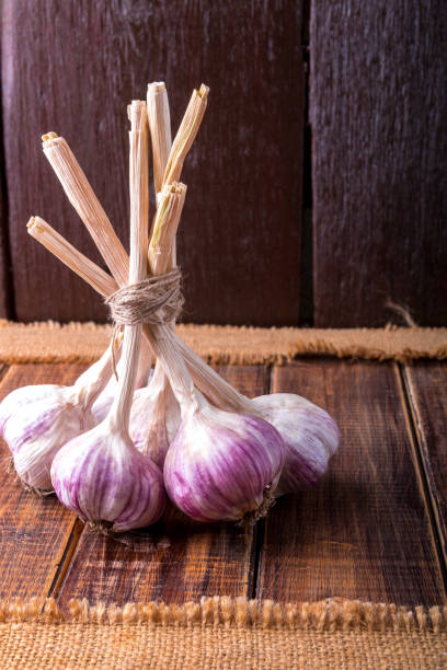 istock Garlic wrapped with twine on wooden background. Rustic. 688901172