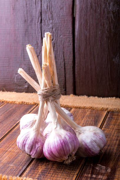 istock Garlic wrapped with twine on wooden background. Rustic. 688901176
