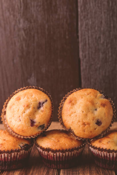 istock Muffins on wooden background on rustic style. Cupcake with currant. Copy space. 688903324