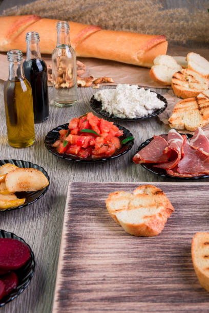 istock Ingredient for bruschetta on wooden background. Close up 688904028