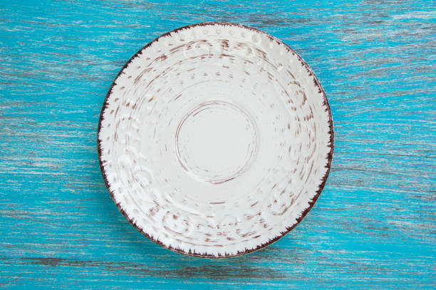 istock Shabby plate on wood background 688907332